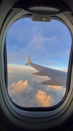 an airplane window looking out into the clouds