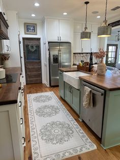 a kitchen with an area rug on the floor