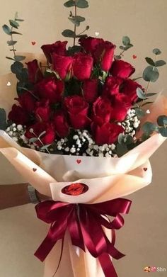 a bouquet of red roses with baby's breath