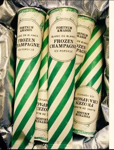 three green and white candy canes sitting on top of tinfoil wrapped in foil