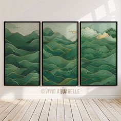 three paintings on the wall in an empty room with wood flooring and white walls