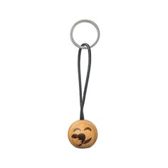 a wooden keychain with a smiley face on it