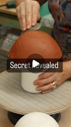 a woman is working on a clay sculpture