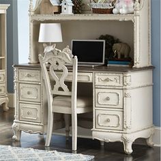 an antique white desk and chair in a room