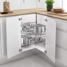 an open kitchen cabinet with pots and pans