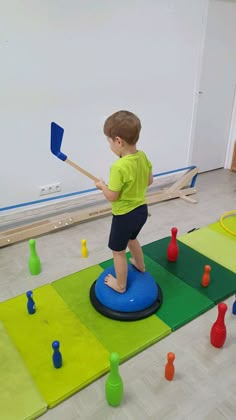 a young boy playing with toys in a room