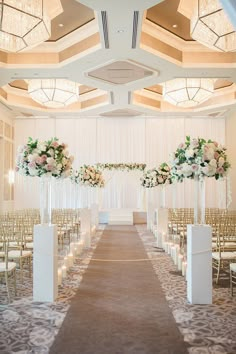 the aisle is lined with white and pink flowers