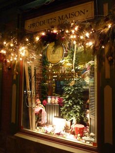 a store window with christmas decorations and lights