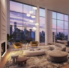 a living room filled with lots of furniture and large windows overlooking the city at night