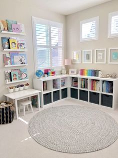 an image of a room with bookshelves and pictures on the wall above it