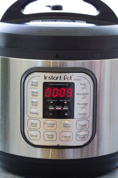 an instant pot is shown with the time displayed on its display screen and it's lid open