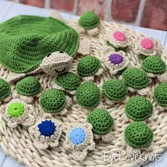 crocheted hat with flowers on it sitting on top of a wicker basket