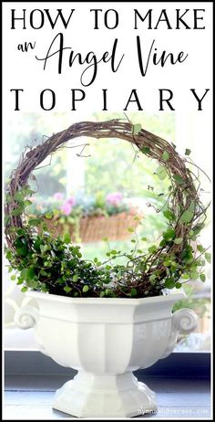 an angel vine wreath sitting on top of a white pedestal in front of a window