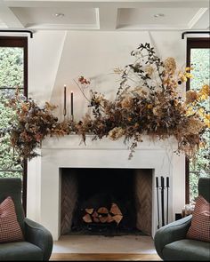 a living room filled with furniture and a fire place in front of a white fireplace