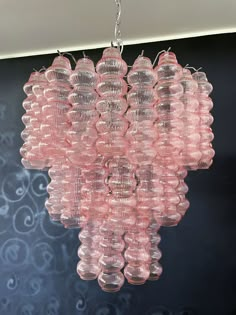 a pink chandelier hanging from a ceiling