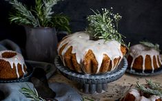 a bundt cake with white icing and greenery on top