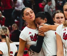 the women's volleyball team is hugging each other