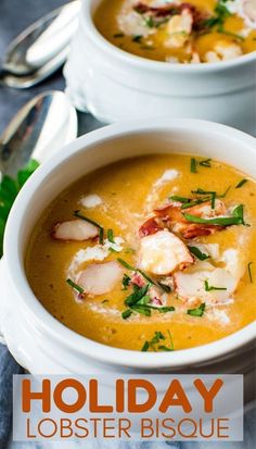 two white bowls filled with lobster soup on top of a table