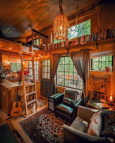 a living room filled with furniture next to a window covered in curtains and a ladder