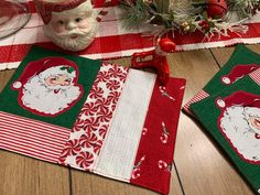 christmas placemats and napkins on a table with santa's face in the center