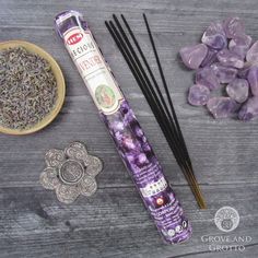 incense sticks, amethyst and crystal stones on a wooden table with decorative items