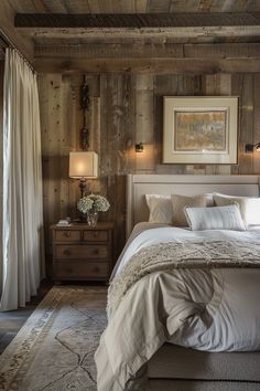 a bedroom with wood paneled walls and white bedding