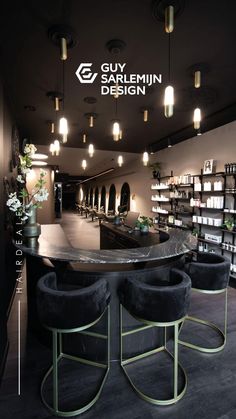 an empty bar with stools in front of it and the logo for guy sarlemin design