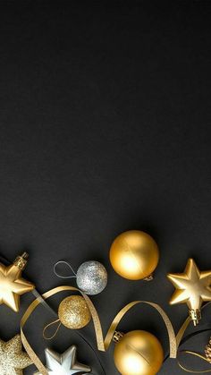 gold and silver christmas ornaments against a black background