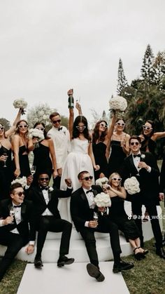 a group of people dressed in black and white posing for a photo