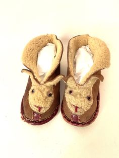 "The child that once wore these bunny slippers was a lucky one: these slippers were well made of cozy, warm lamb. The soles of the slippers measure about 6\".  The slippers are well worn with the binding on the soles rubbed and torn, but still intact. Inside, the soles of the slippers are lined with wool. The faces feature an embroidered smile and glass eyes. There is no label and I am estimating the slippers to be from the 40s or earlier. These are a charming, amusing and rare find." Bunny Slippers, Small Christmas Stockings, Red Flannel, The 40s, Glass Eyes, Antique Books, Christmas Stockings, Vintage Christmas, Kids Shoes