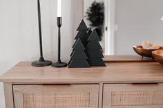 a wooden table with candles and ornaments on it