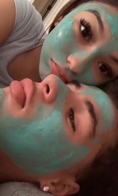 two women with facial masks on their faces are laying down and looking at the camera