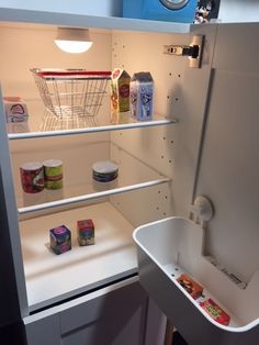 an open refrigerator with food in it and some containers on the shelf next to it