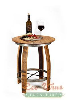 a wine glass sitting on top of a wooden table next to a bottle of wine