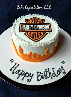 a birthday cake with the name harley davidson cycles on it and an orange motorcycle logo