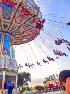 people are riding the merry go round at an amusement park