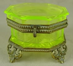 an antique yellow glass box with gold trimmings