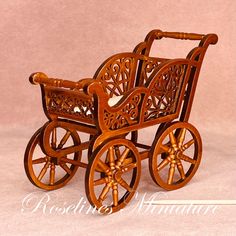 an old fashioned wooden baby carriage with wheels