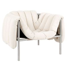 a white chair with a pillow on top of it's back and seat cushion