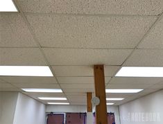 the ceiling in an office building is covered with white speckles and light bulbs