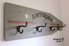 an antique coat rack with hooks and stars on the top, hanging from a wall