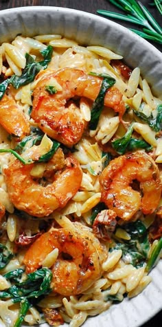 pasta with shrimp and spinach in a white bowl