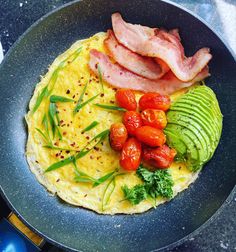 an omelet with bacon, avocado and tomatoes