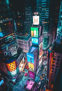 an aerial view of times square in new york city at night with billboards lit up