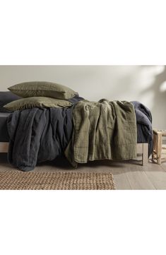 a bed that has some blankets on top of it