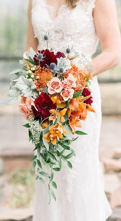 a woman holding a bouquet of flowers in her hands