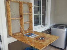 a wooden table with a shelf attached to the top and chains hanging from it's sides