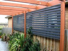 an outdoor area with wooden fence and plants