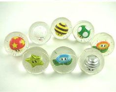 an assortment of glass knobs with cartoon characters on them, all in different shapes and sizes