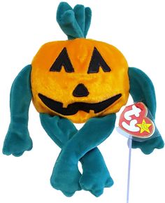 a stuffed animal with a jack - o - lantern on it's head and arms